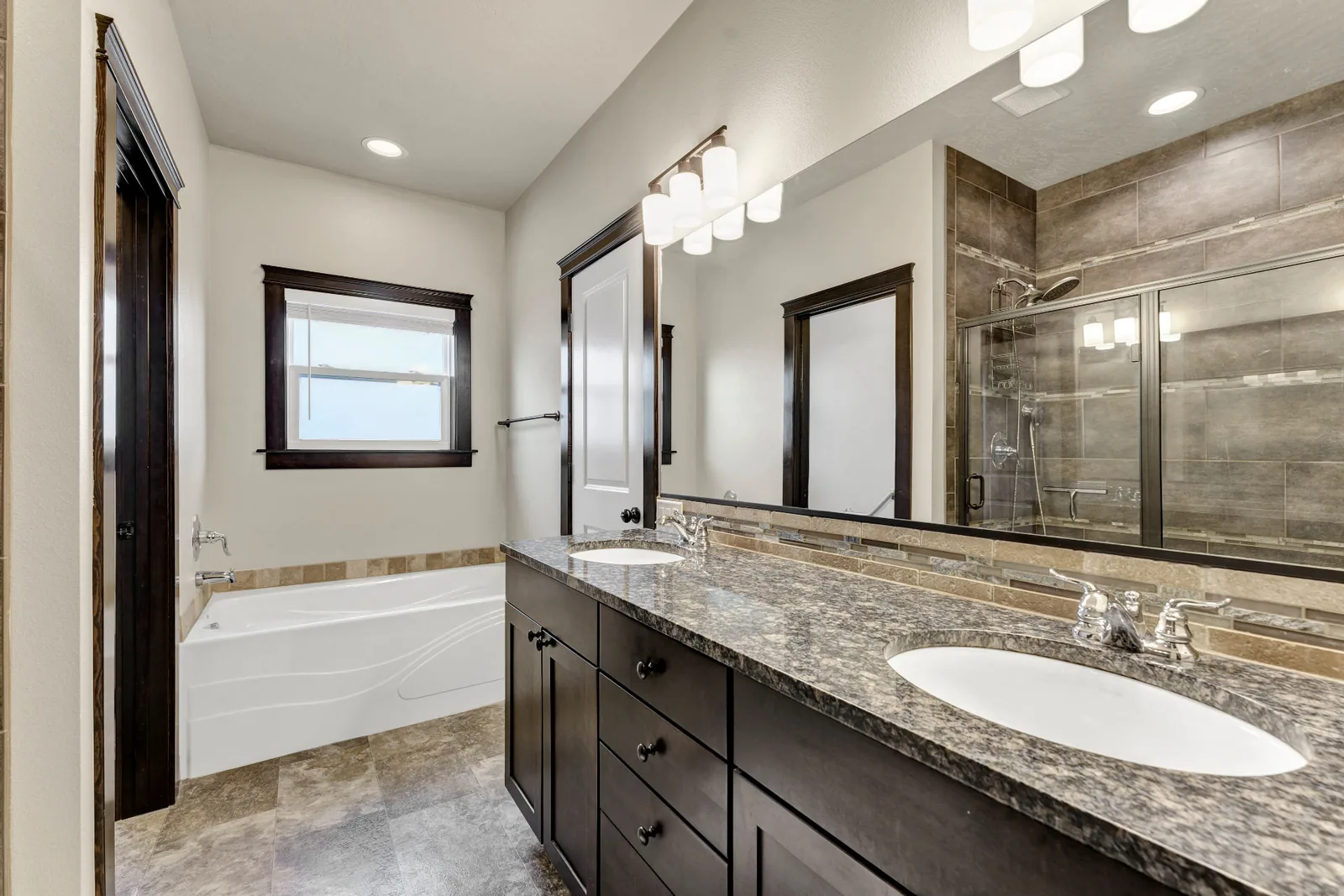 Second full bath with soaking tub, double vanity and tiled shower