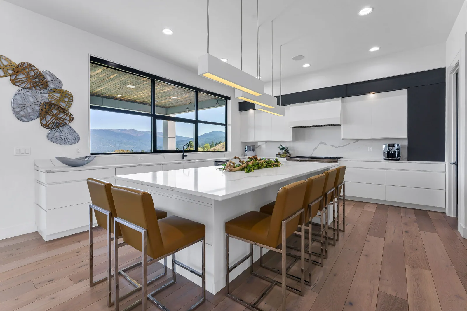 Kitchen with waterfall quartz island, seating for six and mountain view window