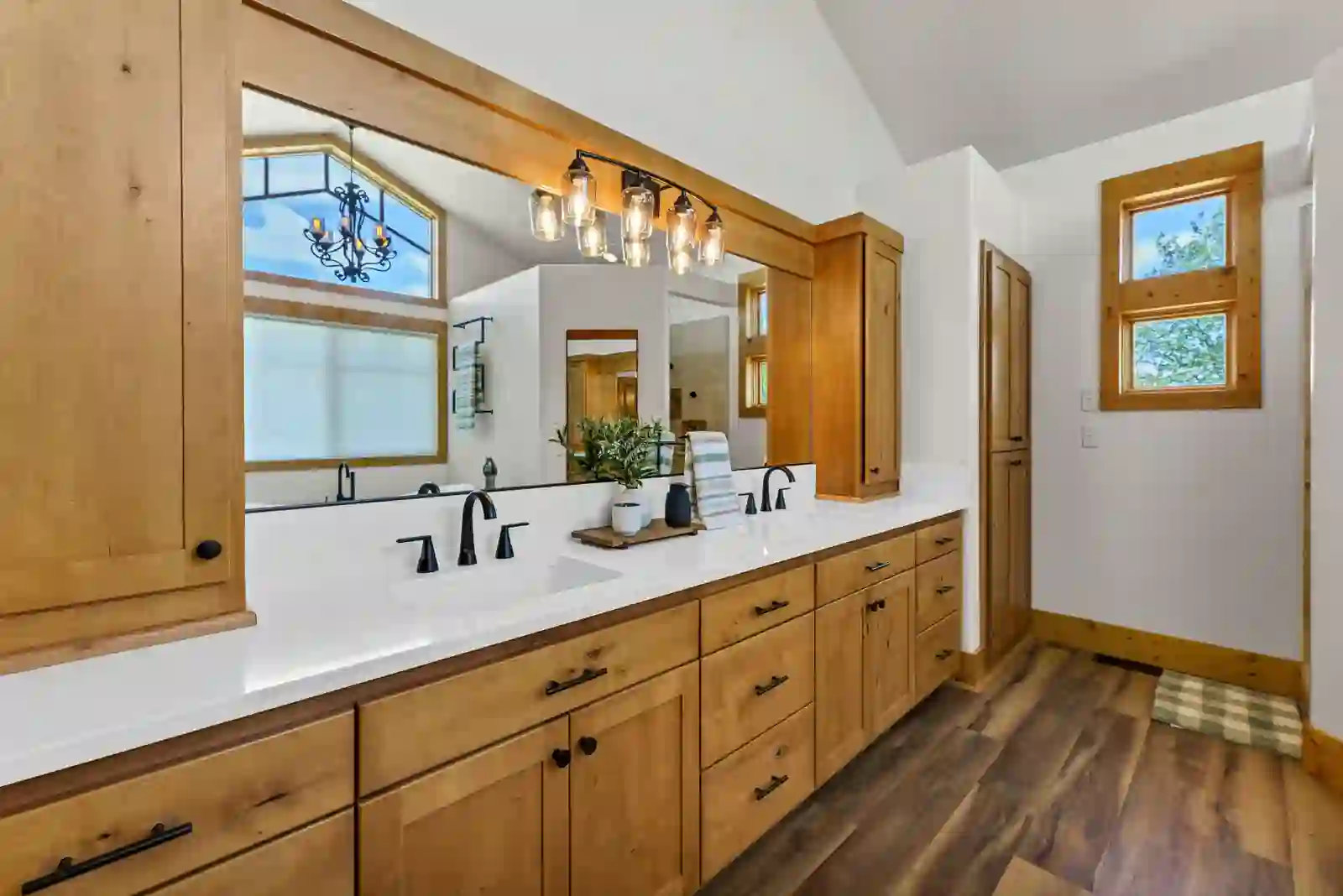 Primary bath double vanity with alder cabinetry and black fixtures