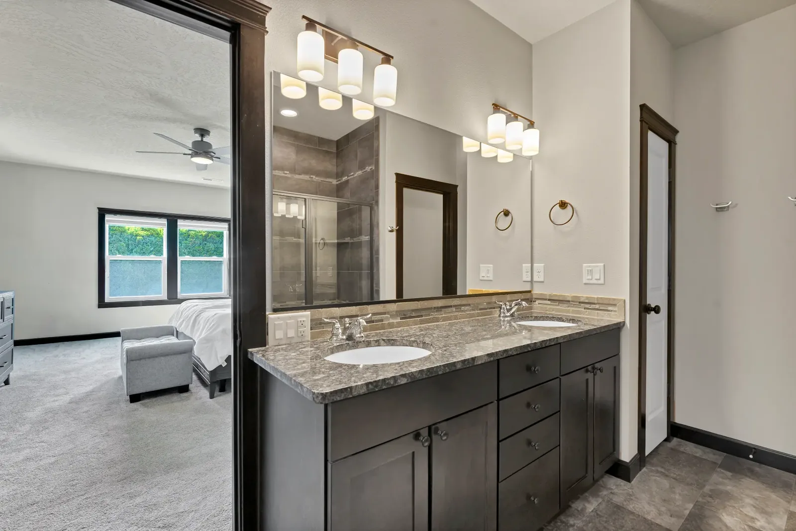 Primary ensuite with double vanity, tile shower and pass-through to the bedroom