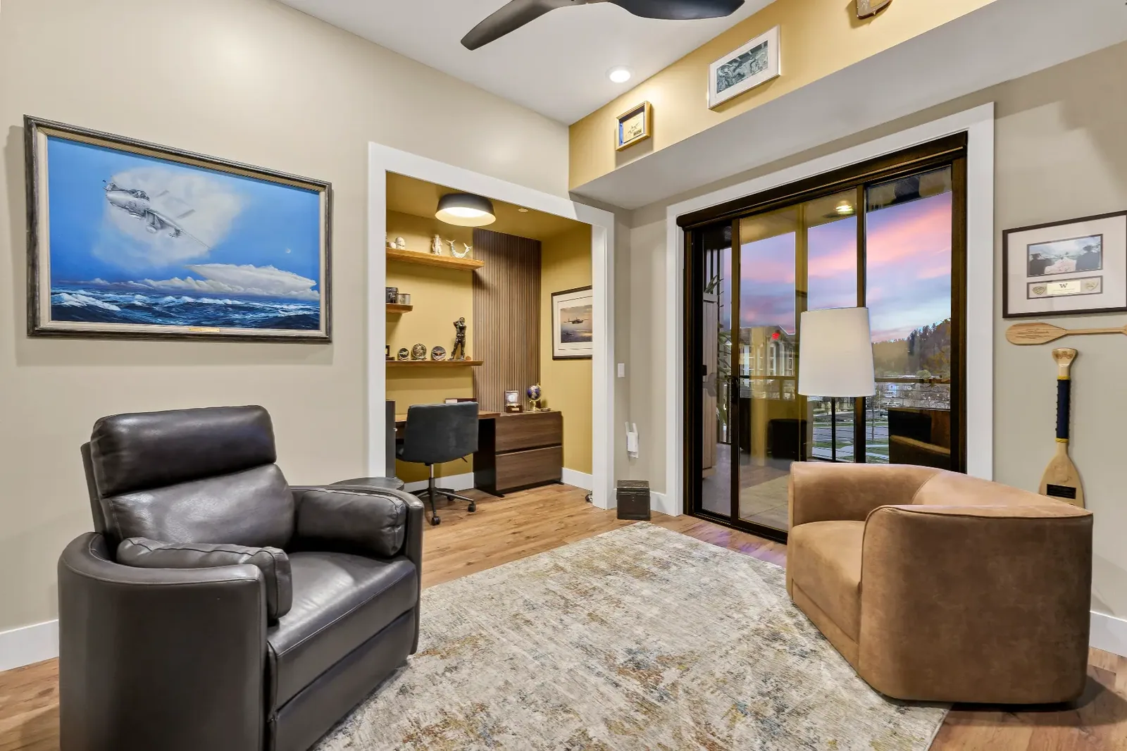 Den and office nook with leather seating and patio access