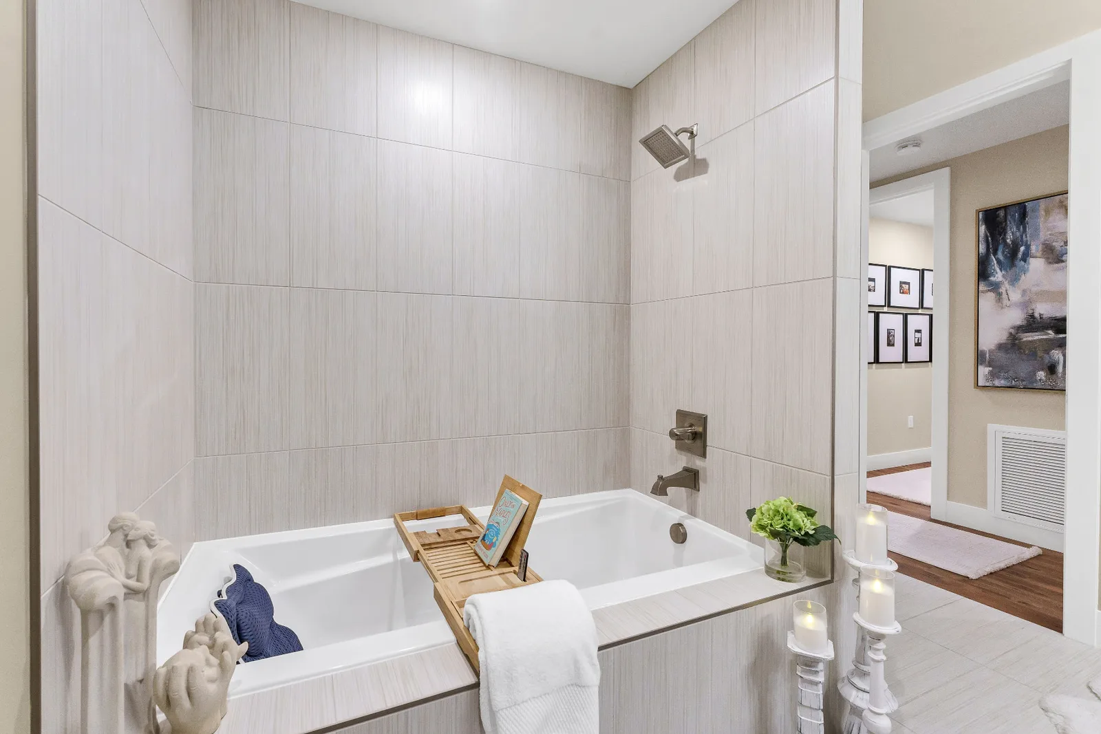 Tiled soaking tub and shower with view down the hallway gallery wall