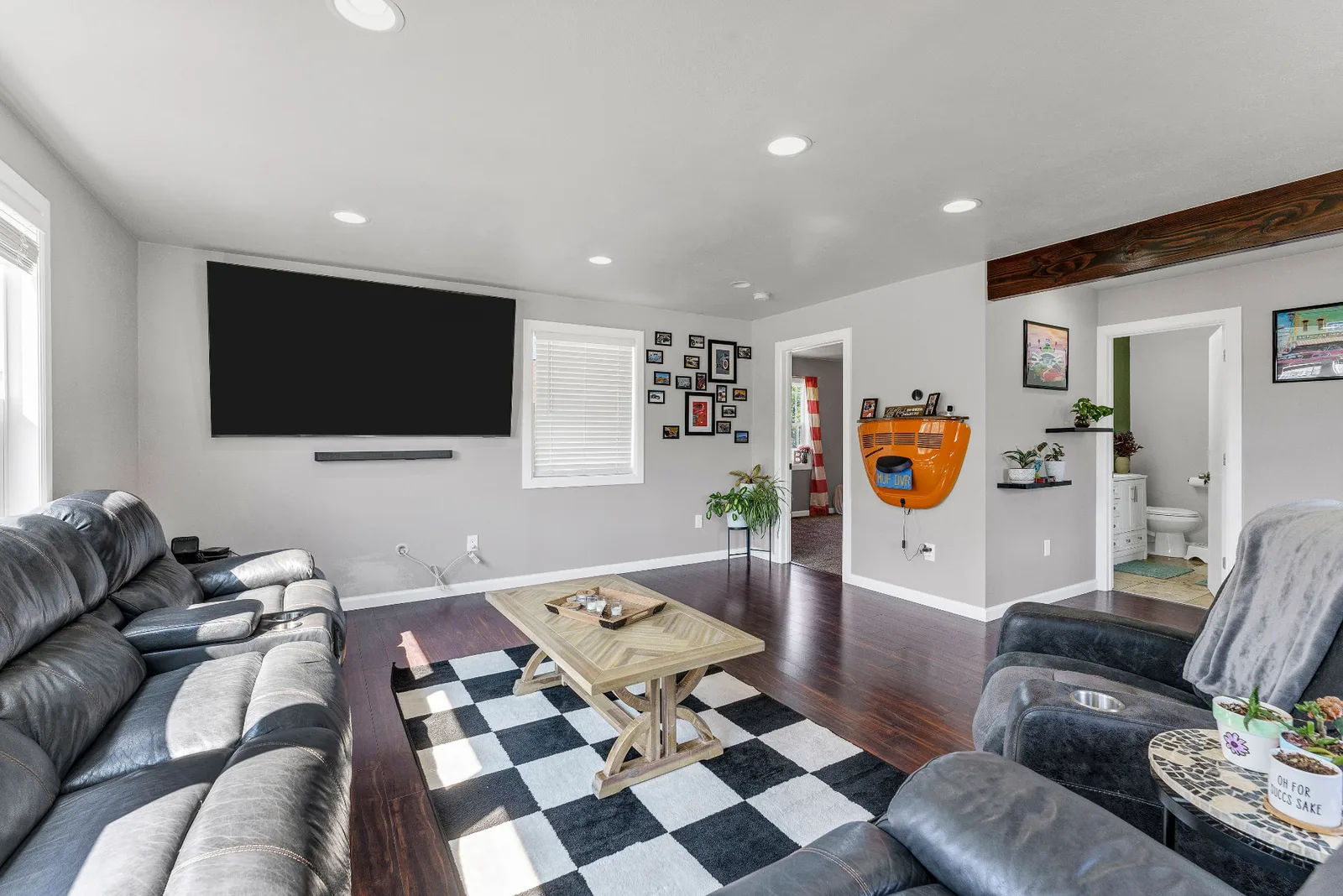 Living room seating area with mounted television and gallery wall