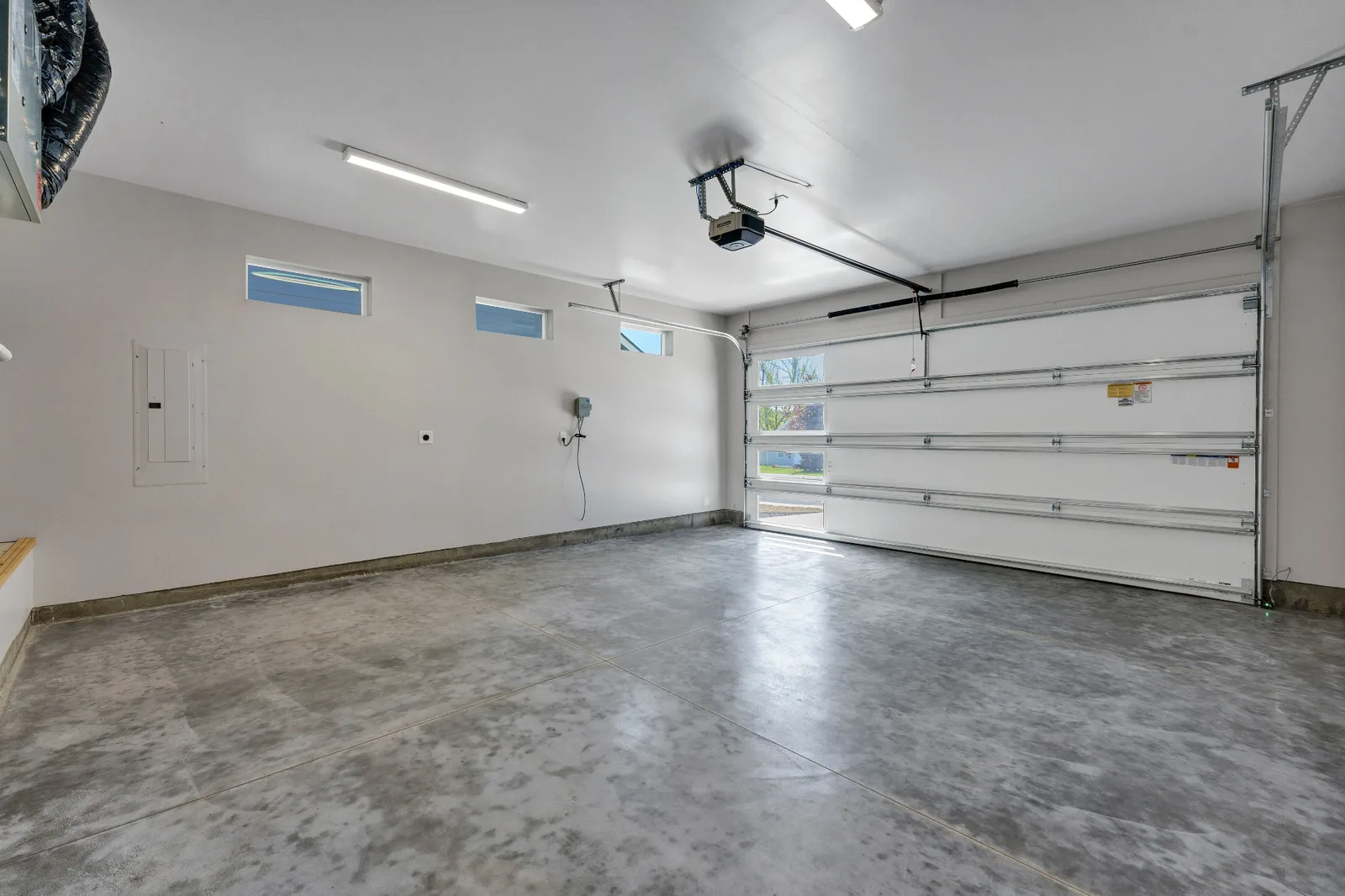 Finished two-car garage with sealed concrete floor and daylight windows